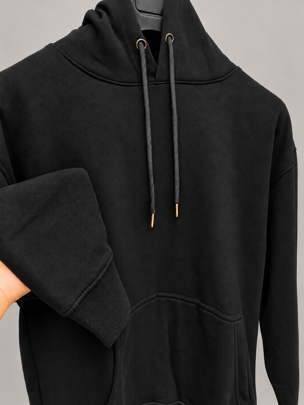 Black pullover hoodie with drawstrings and front pocket