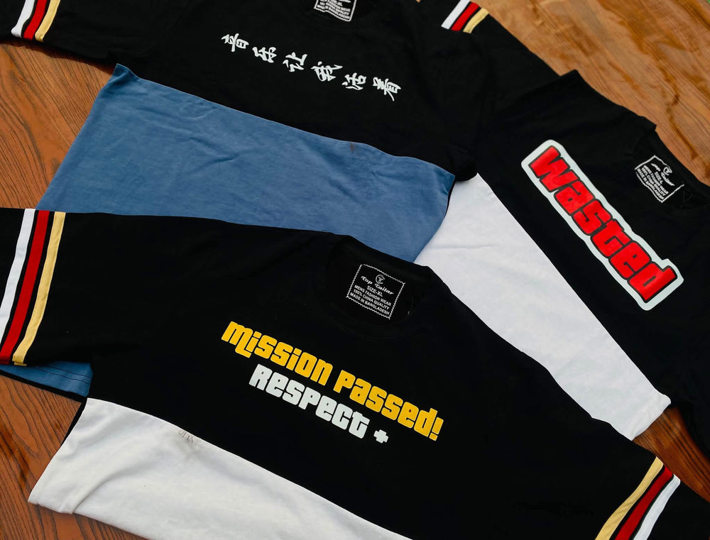 A group of graphic T-shirts laid flat