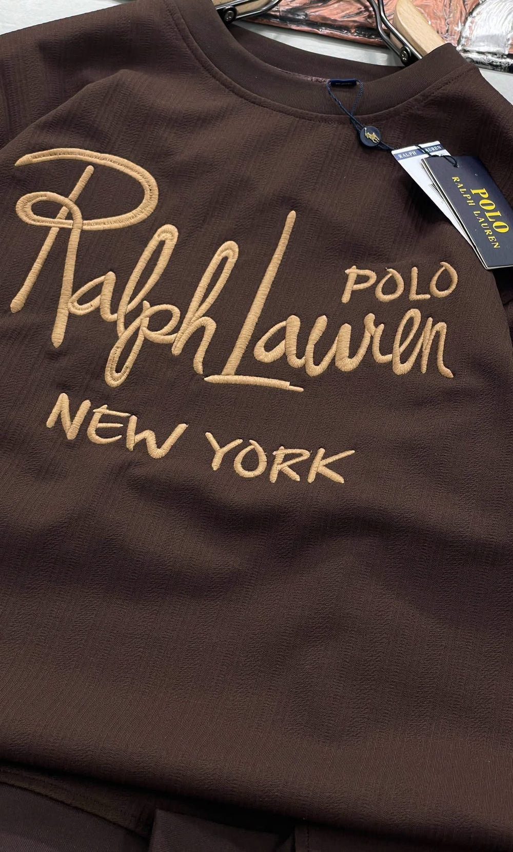 Brown garment with embroidered lettering