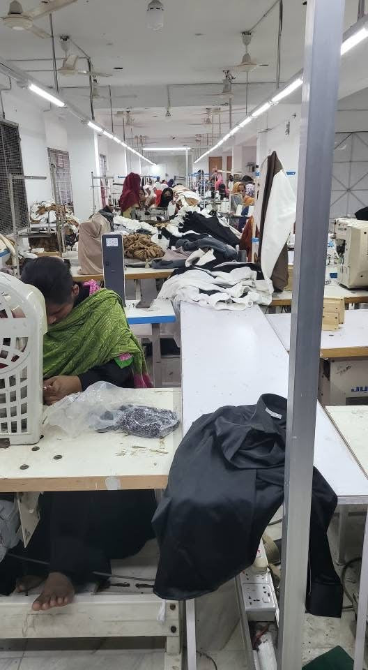 Garment production floor with workstations and fabric